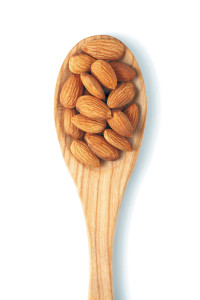 Almonds on wooden spoon