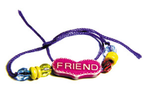 Friendship band of blue thread and different beads.